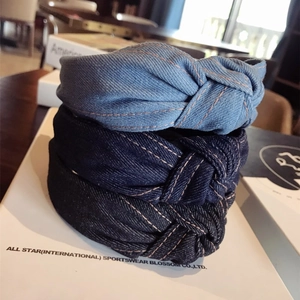 Minimalist twisted denim headbands in light and dark blue with orange contrast stitching