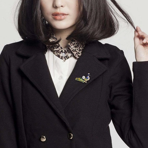 Exquisite peacock brooch with colorful enamel and white pearl on black blazer lapel