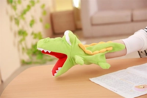 Detailed view of plush crocodile hand puppet with soft green fabric and sharp white teeth