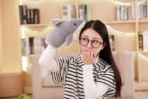 Detail showing a soft plush shark hand puppet being used for interactive storytelling