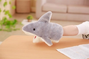 Detail of soft plush shark hand puppet being worn for interactive storytelling and play