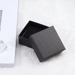 Detail shot of black jewelry gift box with textured diamond pattern and plush lining