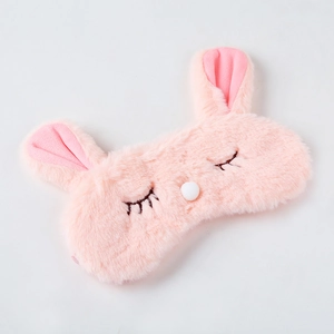 Close-up of pink plush rabbit sleeping mask with long faux fur and embroidery details