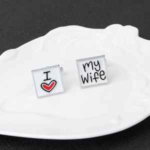 Detail of square silver cufflinks with white enamel featuring I Love My Wife text design