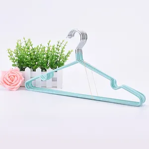 Detail view of non-slip clothes hangers in mint blue with functional shoulder grooves