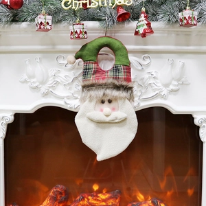 Christmas Santa Claus door hanger in red plaid fabric on a cozy fireplace background