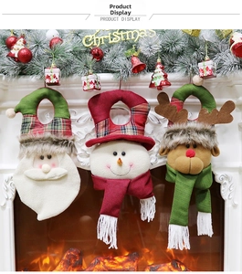 Detailed plush Santa, Snowman and Reindeer Christmas door hangers on a fireplace