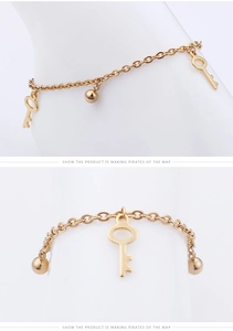 Detail view of golden anklet featuring minimalist key pendants and polished beads