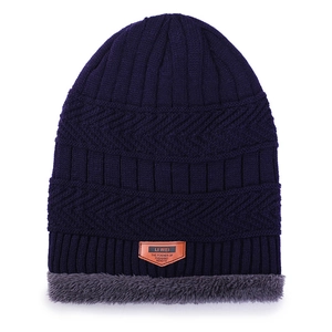 Navy blue winter knit beanie with thick gray plush lining and stylish leather patch