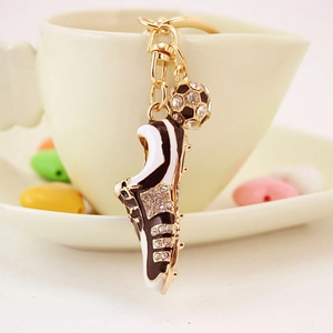 Sparkling soccer shoe keychain with rhinestones and mini football pendant in gold