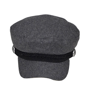 Detail of grey wool newsboy hat with black woven strap and silver metal buttons