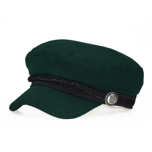 Close-up of dark green wool newsboy hat with braided cord and vintage crown button