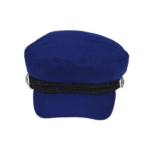 Detail of navy wool blend newsboy cap featuring black braided strap and silver metal buttons