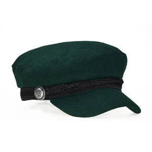 Detail of dark green wool newsboy cap featuring braided cord and crown metal button