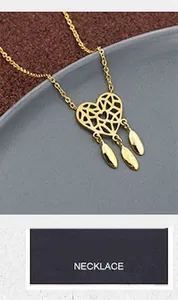 Detailed close-up of a gold hollow heart pendant necklace with three droplet charms