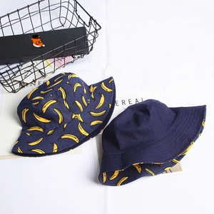 Detail view of double-sided canvas bucket hat with banana print and solid navy blue side