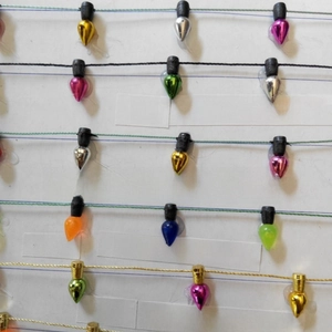 Close-up of assorted electroplated and transparent mini Christmas bulb string decorations