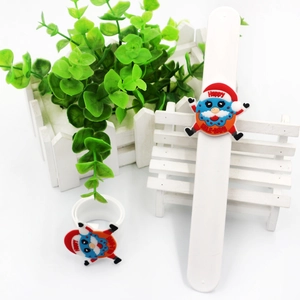 Detail view of a white Christmas silicone slap bracelet with a cute Santa character