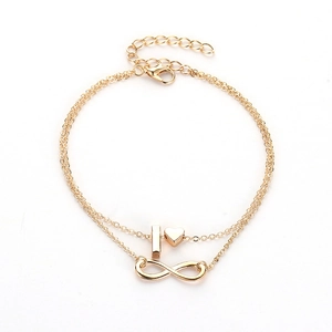 Detail of golden double-layer anklet with heart and infinity symbol pendants