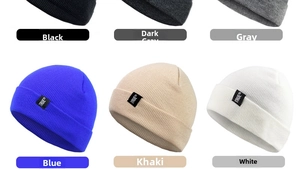 Close-up of knit beanies in various colors showing soft texture and TRUE brand labels