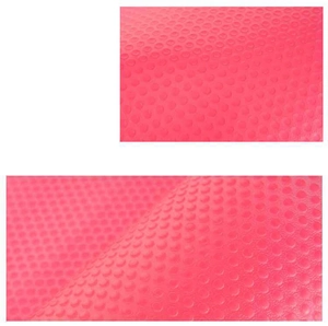 Detailed macro view of pink textured moisture-proof cabinet mat with anti-slip circular patterns