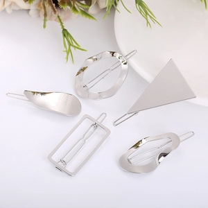 Detailed view of five silver geometric hair clips in various shapes like triangle and rectangle