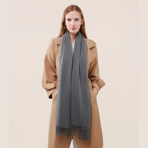 Classic grey cashmere wool scarf with tassels paired with a beige long coat for winter