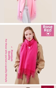 Detail showing soft cashmere scarf texture and delicate rose red fringe tassels