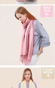 Detailed view of baby pink and milky white wool scarf texture and soft fringe tassels