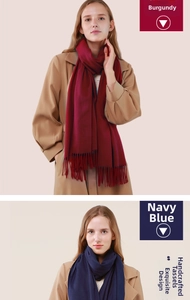 Detail of wine red and navy blue cashmere-feel scarves with classic fringe tassels