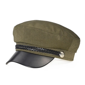 Detail of olive green newsboy cap with black leather brim and silver metal buckle accent