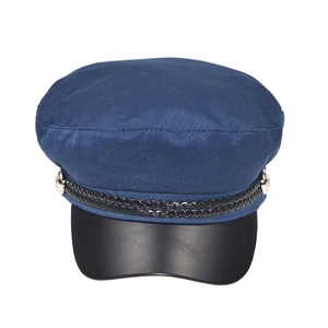 Detail of navy blue newsboy cap with black braided rope and silver metal side buttons
