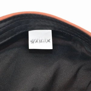 Detail view of cotton-polyester hat interior showing size label and washing instructions