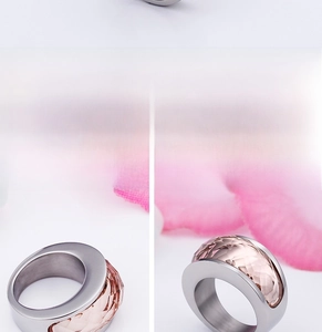 Macro shot of stainless steel wide ring with pink crystal inlay and faceted glass detail