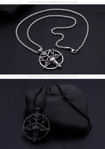 Detail view of silver and black punk goat head pentagram pendants on dark leather