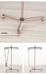 Macro detail of stable tripod base and spinning bronze metal jewelry display stand hooks
