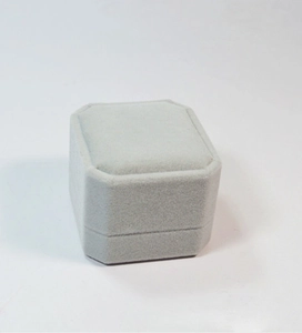 Detailed view of a premium grey velvet ring box with a minimalist faceted rectangular design