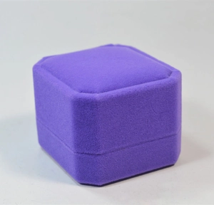 Detail of a purple velvet square jewelry box with elegant beveled corners for rings