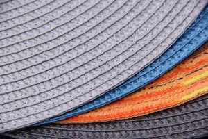 Detailed macro view showing the textured weave and material of colorful round placemats