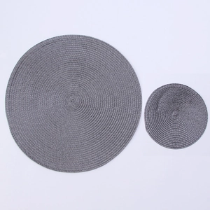 Close-up of grey woven round placemats showing durable texture and heat resistance