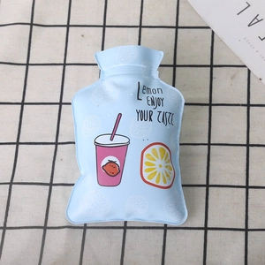 Close-up of a small light blue PVC hot water bottle with cartoon lemon drink pattern