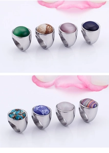 Macro display of diverse colorful cat's eye and turquoise stones in steel ring bands