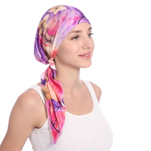 Detail of floral printed headscarf showing the purple gradient pattern and long tail straps