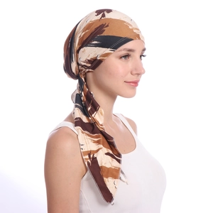 Side view of soft printed turban hat with brown and beige abstract patterns for women