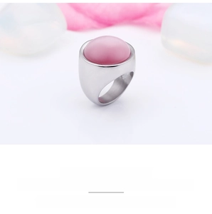 Detailed view of wide polished stainless steel ring with pink opal cabochon inlay