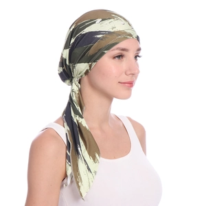 Detailed view of women wearing a camo printed headscarf in green and brown tones