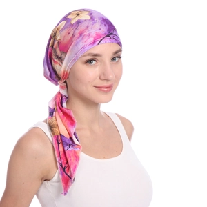 Detail of bohemian floral print on purple and orange milk silk fabric headscarf