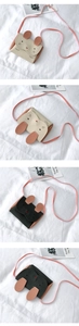 Detailed views of mini rabbit crossbody bags in cream white and black leather colors