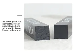 Detail of wooden calendar block showing natural wood grain and white silk-screened months