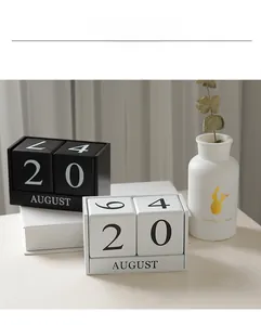 Detailed view of Nordic wood desk calendar with adjustable blocks on a white desk